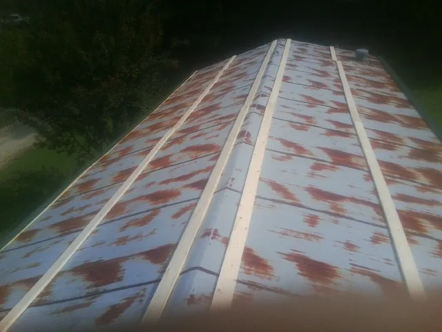 Rusted metal roof panels with new wood purlins before replacement — Storm Damage Roof Repair in Tyner by Roofing Brothers